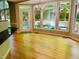 Bright sunroom featuring hardwood floors, natural light, and a view of the backyard at 1512 Cumberland Rd, Chapel Hill, NC 27514