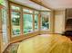 Sunroom showcasing hardwood flooring, a chandelier, and a beautiful view of the outdoors at 1512 Cumberland Rd, Chapel Hill, NC 27514