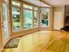 Bright sunroom boasting hardwood flooring, large windows, and access to an outdoor deck at 1512 Cumberland Rd, Chapel Hill, NC 27514