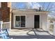 Relaxing back deck featuring a sliding glass door, a single door, and a brick chimney at 1536 Maybrook Dr, Raleigh, NC 27610
