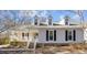 Charming home featuring dormer windows, black shutters, and a welcoming front porch at 1536 Maybrook Dr, Raleigh, NC 27610