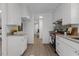 Bright kitchen features white cabinets, stainless steel appliances, and view of the hall at 1536 Maybrook Dr, Raleigh, NC 27610