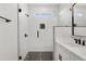 Close up of a bathroom shower with black hexagon tile floor and black hardware at 162 Gumtop Dr, Zebulon, NC 27597
