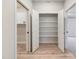 Walk-in closet featuring a wall of shelving and wood-look floors at 162 Gumtop Dr, Zebulon, NC 27597