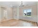 Elegant dining room featuring a modern chandelier, beautiful wainscoting, and hardwood floors at 162 Gumtop Dr, Zebulon, NC 27597