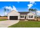 Charming, single-story home with a well-manicured lawn and a two-car garage at 162 Gumtop Dr, Zebulon, NC 27597