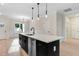 Kitchen with a large island with a stainless steel dishwasher and sink, and modern pendant lighting at 162 Gumtop Dr, Zebulon, NC 27597