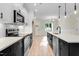 Bright kitchen features stainless steel appliances, white cabinetry, and a spacious island with a sink at 162 Gumtop Dr, Zebulon, NC 27597