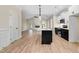Bright, open kitchen with white cabinetry, a dark island with sink, and stainless appliances at 162 Gumtop Dr, Zebulon, NC 27597