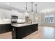 Bright kitchen with a dark island, stainless appliances and ample counter space, great for entertaining at 162 Gumtop Dr, Zebulon, NC 27597