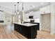 Bright, open kitchen features a dark island with a sink and stainless appliances, perfect for entertaining at 162 Gumtop Dr, Zebulon, NC 27597