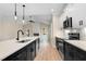 White kitchen cabinets compliment the dark island, stainless appliances, and bright white counter tops at 162 Gumtop Dr, Zebulon, NC 27597