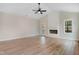 Open-concept living room featuring hardwood floors, a fireplace, and a back door at 162 Gumtop Dr, Zebulon, NC 27597