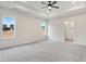 The main bedroom features tray ceilings, neutral walls, plush carpet, and a ceiling fan at 162 Gumtop Dr, Zebulon, NC 27597