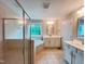 This primary bathroom features a stand up shower, soaking tub, double vanity, and tile flooring at 1746 Hammocks Beach Trl, Apex, NC 27502