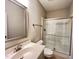 Clean bathroom with tile floors, a vanity, a framed mirror, and a glass-enclosed shower at 1746 Hammocks Beach Trl, Apex, NC 27502