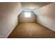 Attic bedroom features carpet flooring, neutral walls, and a single window at 1746 Hammocks Beach Trl, Apex, NC 27502