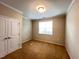 Cozy bedroom with neutral carpet, double closets, and a bright window for natural light at 1746 Hammocks Beach Trl, Apex, NC 27502