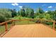 Expansive wooden deck overlooking a lush, green backyard, perfect for outdoor gatherings at 1746 Hammocks Beach Trl, Apex, NC 27502