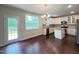Eat-in kitchen features an island, stainless steel appliances, and an adjacent deck access at 1746 Hammocks Beach Trl, Apex, NC 27502
