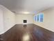 Open living room with dark hardwood floors, a fireplace, and abundant natural light at 1746 Hammocks Beach Trl, Apex, NC 27502