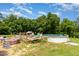 Backyard featuring a swimming pool, deck, and beautiful green trees in the background at 1770 Gentry Ridge Rd, Roxboro, NC 27574