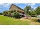 A large backyard, featuring lush greenery, a deck and the rear of a brick home at 1770 Gentry Ridge Rd, Roxboro, NC 27574
