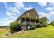 A large brick home with an inviting backyard and a covered porch overlooking green space at 1770 Gentry Ridge Rd, Roxboro, NC 27574