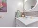 Bright powder room with a white vanity and decorative mirror at 1770 Gentry Ridge Rd, Roxboro, NC 27574