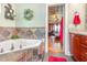 Bright bathroom featuring a tiled jacuzzi tub, granite countertops, and entry to another room at 1770 Gentry Ridge Rd, Roxboro, NC 27574