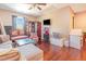 Eclectic bedroom with hardwood floors, sitting area, lots of furniture, and lots of decorative items at 1770 Gentry Ridge Rd, Roxboro, NC 27574