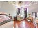 Bedroom featuring hardwood floors, sitting area, window lighting, and dark curtains at 1770 Gentry Ridge Rd, Roxboro, NC 27574
