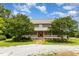 Charming two-story brick home with a inviting front porch, beautiful trees, and ample outdoor space at 1770 Gentry Ridge Rd, Roxboro, NC 27574