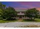 Charming two-story brick home with a inviting front porch, beautiful trees, and ample outdoor space at 1770 Gentry Ridge Rd, Roxboro, NC 27574