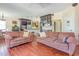 Open living room with a view to the kitchen, wooden floors, and comfortable couches at 1770 Gentry Ridge Rd, Roxboro, NC 27574