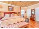 Bright main bedroom with wooden ceiling, wood floors, and a large bed at 1770 Gentry Ridge Rd, Roxboro, NC 27574