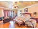 Large primary bedroom with wood floors, ceiling fan and private bath at 1770 Gentry Ridge Rd, Roxboro, NC 27574