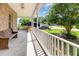 Outdoor porch featuring bright lighting and wooden bench and railing at 1770 Gentry Ridge Rd, Roxboro, NC 27574