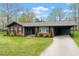 Charming single-story brick house with a well-manicured lawn and an attached carport at 1813 Grady Dr., Durham, NC 27712