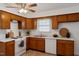 Cozy kitchen featuring wooden cabinets, white countertops, and a window for natural light at 1813 Grady Dr., Durham, NC 27712
