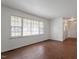 Bright living room with large windows and wood-look flooring, offering a clean and inviting space at 1813 Grady Dr., Durham, NC 27712