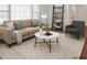 Bright living room featuring hardwood floors, a beige couch, and a stylish coffee table at 1813 Grady Dr., Durham, NC 27712