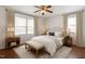 Bright main bedroom featuring hardwood floors, neutral colors, and large windows with curtains at 1813 Grady Dr., Durham, NC 27712