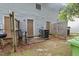 Enclosed backyard patio featuring dual entry doors, space for seating, and privacy fence at 1824 Vintage Rd, Raleigh, NC 27610