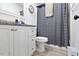 Bathroom with modern vanity, updated fixtures, a toilet, and decorative shower curtain at 1824 Vintage Rd, Raleigh, NC 27610