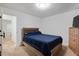 Cozy bedroom featuring carpet floors, light walls, and a bed with blue comforter at 1824 Vintage Rd, Raleigh, NC 27610