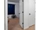 Cozy bedroom features white doors, a window with blue curtains, and neutral carpet at 1824 Vintage Rd, Raleigh, NC 27610