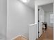 Upstairs hallway showing white walls and trim, carpeted floors, and a doorway into another room at 1824 Vintage Rd, Raleigh, NC 27610
