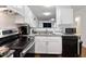 Modern kitchen with granite countertops, stainless steel appliances, and sleek cabinetry at 1824 Vintage Rd, Raleigh, NC 27610