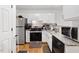 Modern kitchen featuring stainless steel appliances, white cabinetry, and sleek countertops at 1824 Vintage Rd, Raleigh, NC 27610
